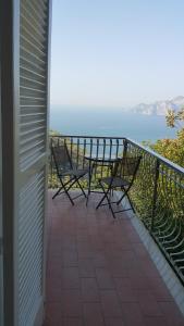 a balcony with two chairs and a view of the ocean at Acquamarina Accommodation in Massa Lubrense