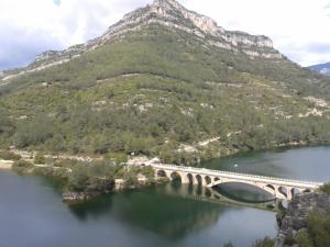 a bridge over a river with mountains at Hostal Casa Manolo in La Senia