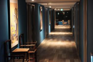 a corridor with chairs and tables in a room at Happy Inn in Taichung