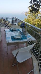 a table on a balcony with a view of the water at Acquamarina Accommodation in Massa Lubrense