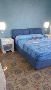 a bedroom with a blue bed with a dolphin on it at Acquamarina Accommodation in Massa Lubrense
