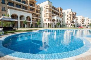 a large swimming pool in front of some buildings at Lighthouse Golf Apart Complex&Villas in Balchik