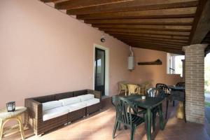 a living room with a couch and a table and chairs at Agriturismo Le 3 Rose in Antria