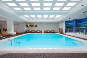 a large pool in a hotel with a slide at Melia Madeira Mare in Funchal