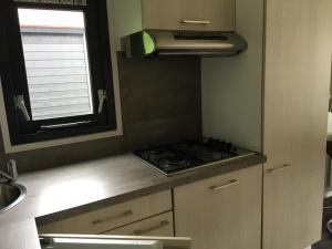 a kitchen with a stove and a window at Landgut Jungfleisch in Gries