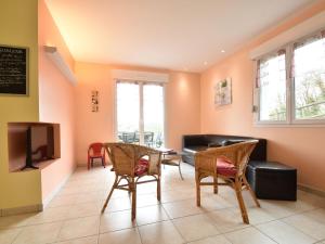 a living room with a couch and chairs and a tv at Family Stay in Normandy in Villedieu-les-Poëles