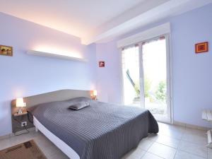 a bedroom with a bed and a large window at Family Stay in Normandy in Villedieu-les-Poëles