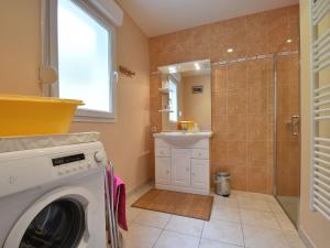 a washing machine in a bathroom with a shower at Family Stay in Normandy in Villedieu-les-Poëles