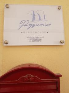a sign on the wall of a guest house at Poggiamico Guest House in Favignana