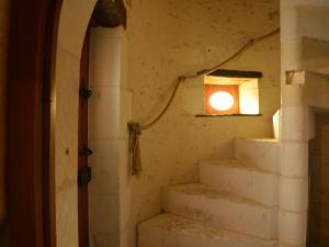 a stairway with a light on the wall at Beautiful holiday home with private pool in Boussageau