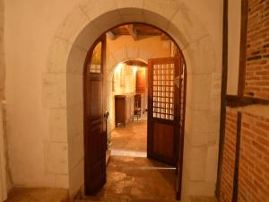 an arched hallway with a door and a brick wall at Beautiful holiday home with private pool in Boussageau