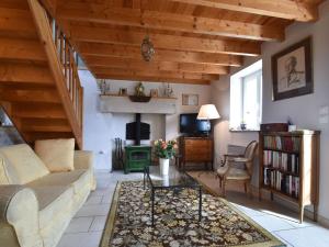 a living room with a couch and a fireplace at Cozy Cottage in Fresville with Garden in Fresville