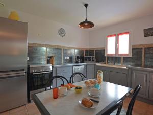 a kitchen with a table with food on it at Cozy Villa in Saint Victor de Malcap with Swimming Pool in Saint-Victor-de-Malcap
