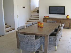 a dining room with a wooden table and chairs at Opulent Villa in Le muy with Swimming Pool in Le Muy