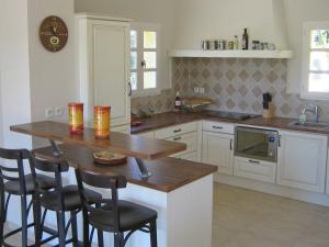 a kitchen with a table with chairs and a microwave at Opulent Villa in Le muy with Swimming Pool in Le Muy