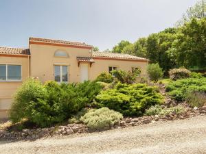 a house with a garden in front of it at Peaceful Villa in Calamane with Private Pool in Calamane