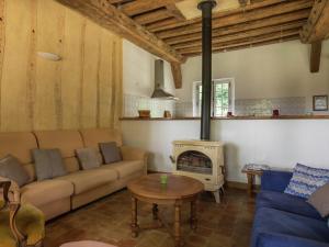 a living room with a couch and a fireplace at Holiday home with private terrace in Saint-Aignan