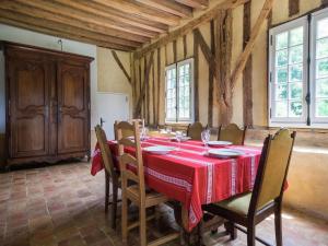 una sala da pranzo con tavolo e sedie rossi di Holiday home with private terrace a Saint-Aignan