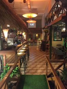 a restaurant with a long bar with tables and chairs at Great Value Family Apartment to Family Apartment @ M-City in Kuala Lumpur