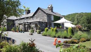 a stone building with a parking lot in front of it at Aberdunant Hall in Porthmadog