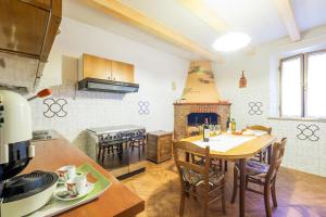a kitchen with a table and a dining room at Impronta di Gaia in Foiano della Chiana