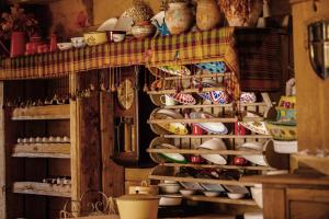 a shelf filled with lots of bowls and plates at Fidanka Hotel in Kalkan