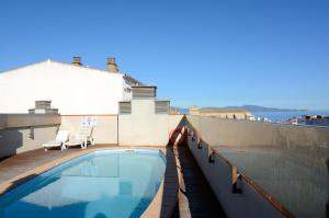 a swimming pool on the roof of a building at Apartamentos Mestral in L'Escala