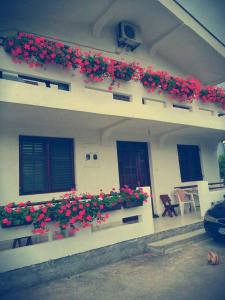 a building with flowers on the side of it at Apartman Tripkovic in Bar
