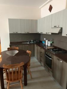 a kitchen with a table and chairs and a stove at Bugibba Homes Suite in St Paul's Bay