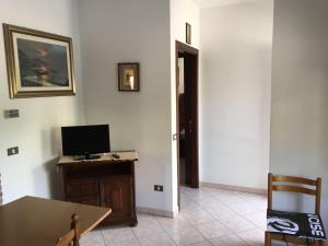 Habitación con escritorio y mesa con TV. en Appartamento Biancospino, en Gualdo Tadino