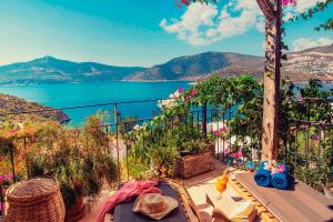 a balcony with a view of the water and mountains at Fidanka Hotel in Kalkan