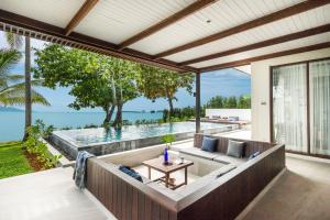 an outdoor living room with a view of the ocean at NH Collection Samui Peace Resort in Bophut