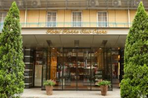 a store front with two potted trees in front of it at Hotel Hokke Club Osaka in Osaka