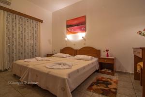 A bed or beds in a room at Roula Apartments