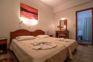 A bed or beds in a room at Roula Apartments