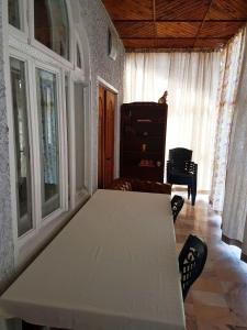 a living room with a white table and a piano at Pensiunea Geostar 2 in Curtea de Argeş
