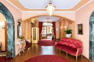a living room filled with furniture and a red carpet at Romantik Hotel Bülow Residenz in Dresden
