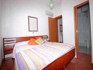 リニャーノ・サッビアドーロにあるVilla Lilianaのベッドルーム1室(オレンジと黄色の枕が付いたベッド1台付)