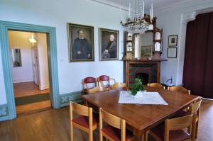 a dining room with a table and a fireplace at Hellidens Slott in Tidaholm +53 photos