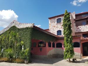 a house with ivy growing on the side of it at Hotel La Hasienda in Kupang