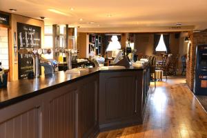 a bar in a restaurant with a counter top at Unicorn, Gunthorpe by Marston's Inns in Lowdham