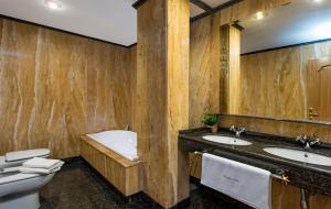 a bathroom with two sinks and a toilet and a mirror at Genteel Home Plaza Nueva Granada in Granada +53 photos