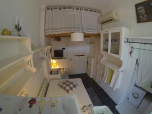 a small kitchen with white cabinets and a table at Guest House Ilicki Plac in Zagreb