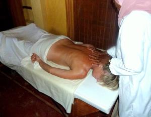 a woman laying on a bed in a room at Sawadi Ecolodge in Skoura