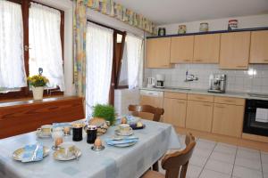 a kitchen with a table with dishes on it at Bergfranzenhof in Oppenau