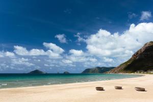 three bowls sitting on a beach next to the ocean at Six Senses Con Dao - Turtle Island Paradise in Con Dao