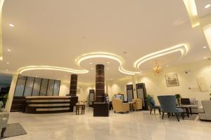 a lobby with a waiting area with chairs and tables at Top View - شقق المنظر in Al Hofuf