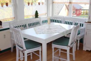 un comedor blanco con una mesa y sillas blancas en Ferienwohnung Villa Parkblick, en Oberhof