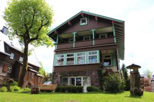a house with a bench in front of it at Ferienwohnung Villa Parkblick in Oberhof +7 photos