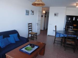 een woonkamer met een blauwe bank en een tafel bij Rocamaura II 2 8 inmoestartit in L'Estartit